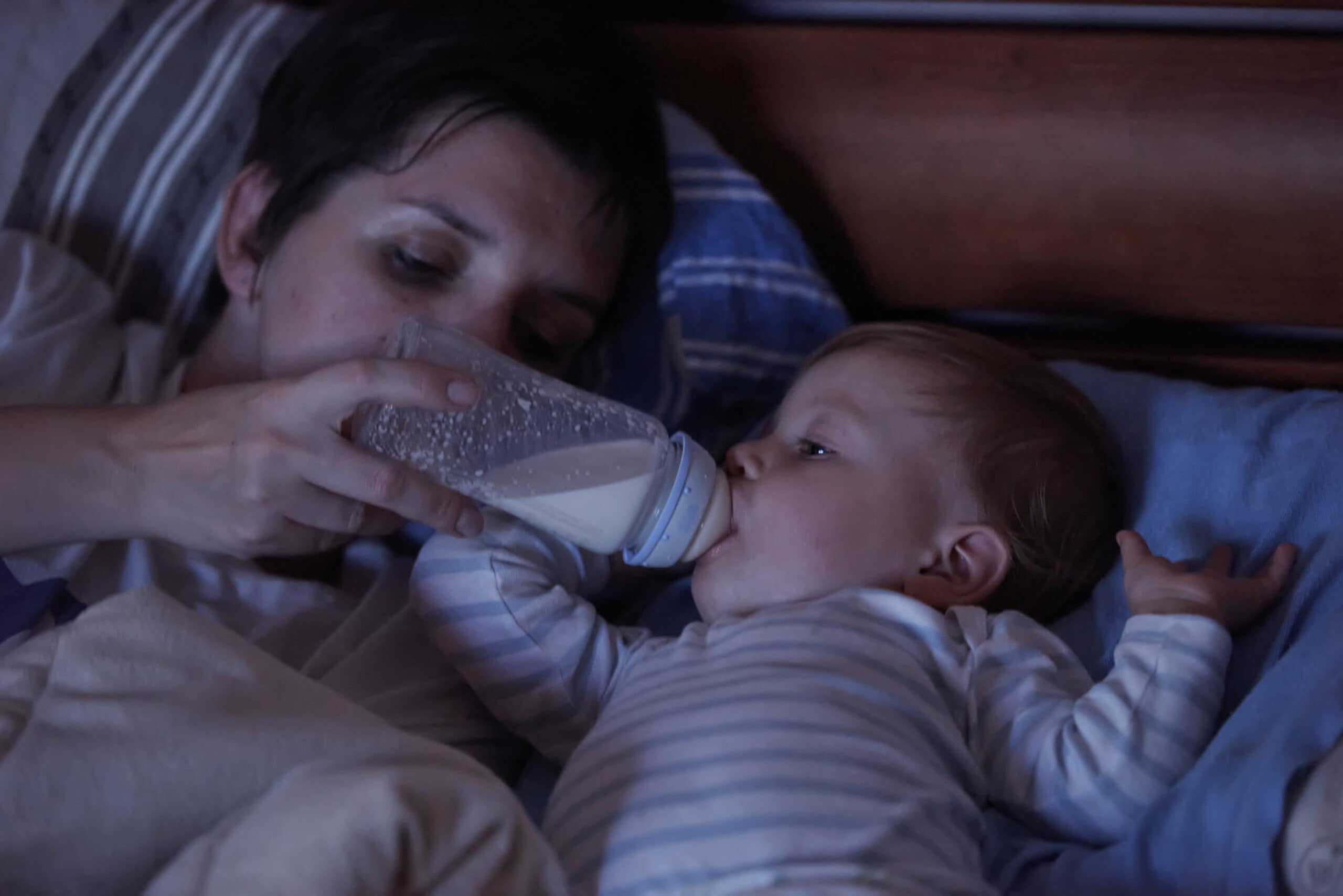 baby eating milk from bottle